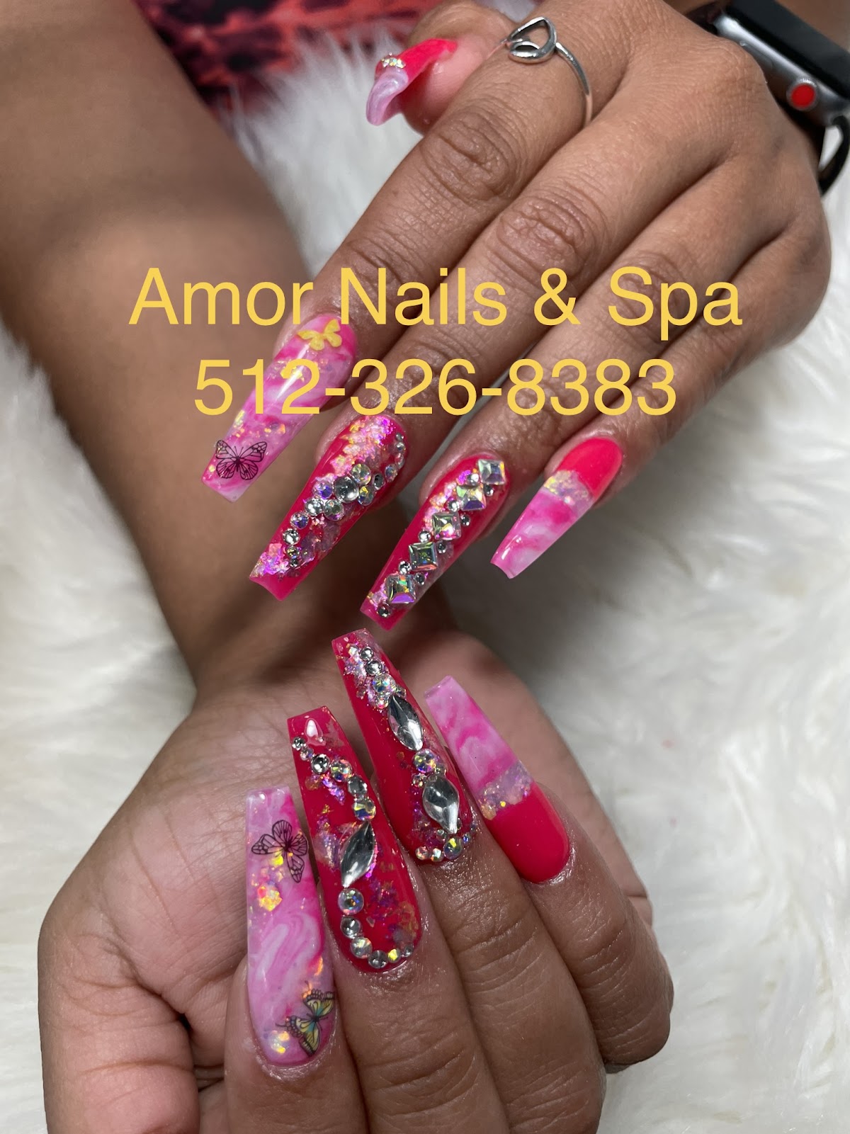 Pink rhinestone and butterfly coffin nails, an Amor Nails and Spa branded photo